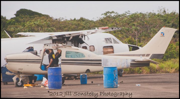 Abandoned airplane on Utila Police officials strip an abandoned airplane on the airport tarmac of Utila, Honduras