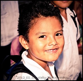 A smiling young boy poses to have his picture taken at the public school (CEBRH) in Utila, Honduras.
