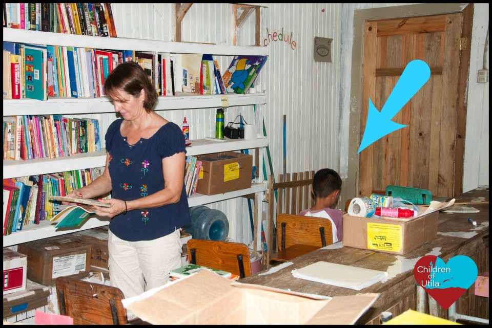 little boy reading in the first ever library in his school