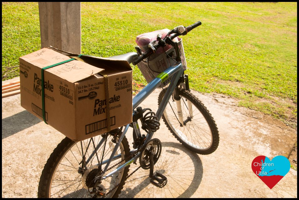 Donated school supplies assembled into packages and put in a box on my bike to deliver to each teacher at Utila's public school